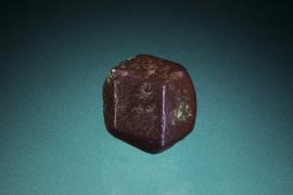 Copper, Eagle Harbor, Michigan. A small but near perfect crystal of copper showing a simple dodecahedral form. Specimen 3.5 cm across. Photo by M. Schorr.  (UM 1689)