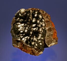 Goethite, Steeprock Mine, Atikokan, Ontario. Lustrous botryoidal goethite on weathered iron ore. Specimen 9 cm tall. Photo by G. Robinson. (DM 22760)