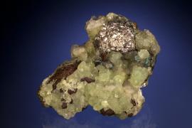 Silver, prehnite and copper, Quincy Mine, Houghton County, Michigan. An unusual “ball” of silver crystals on a matrix of prehnite and copper. From collection of J. T. Reeder. Specimen 7.5 cm long. Photo by J. Jaszczak and C. Stefano. (JTR 493)
