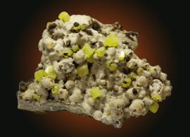 Sulfur and calcite, Sicily, Italy. The UM mineral collection contains a suite of sulfur minerals from Walter Hunt's doctoral research. Donor. W. Hunt. Specimen 19 cm wide. Photo by C. Stefano. (UM4716)