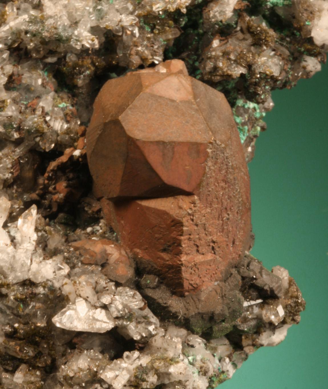 Copper, Quincy Mine, Houghton County, Michigan. A sharp, elongated dodecahedral crystal with red cuprite coating. From the collection of J. T. Reeder. Field of view is about 5 cm wide. Photo by G. Robinson. (JTR 1642)