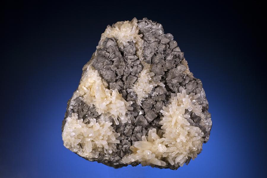 Antimony, calcite, Lake George Mine, New Brunswick, Canada. The largest specimen collected from the discovery that has produced the finest examples of native antimony ever found. Specimen 16 cm tall. Photo by J. Jaszczak and C. Stefano. (DM 22994)