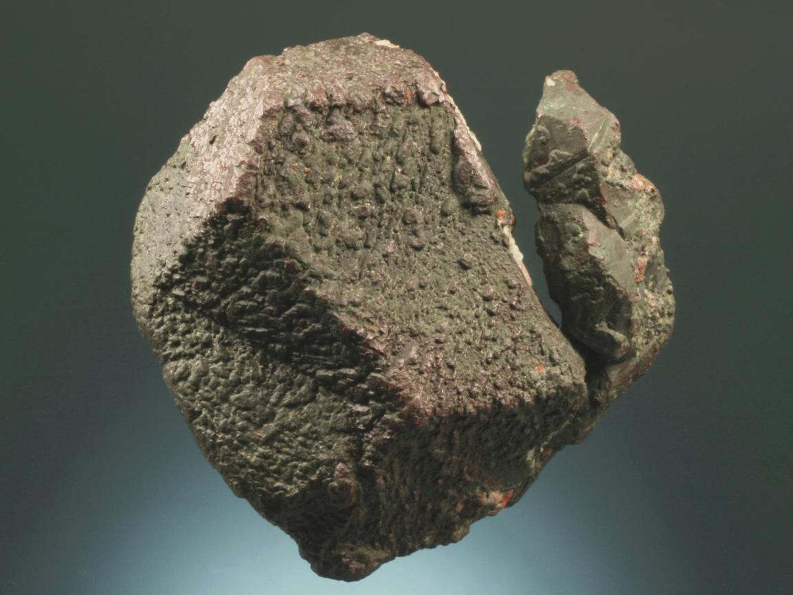 Copper, Belt Mine, Ontonagon County, Michigan. An exceptionally large twinned dodecahedron of copper. This specimen was collected from the mine dump in 2004. It is extremely rare for such outstanding specimens to be recovered from the mine dumps. Donor: members of the A. E. Seaman Mineral Museum. Specimen 6.5 cm tall. Photo by G. Robinson. (DM 27712)