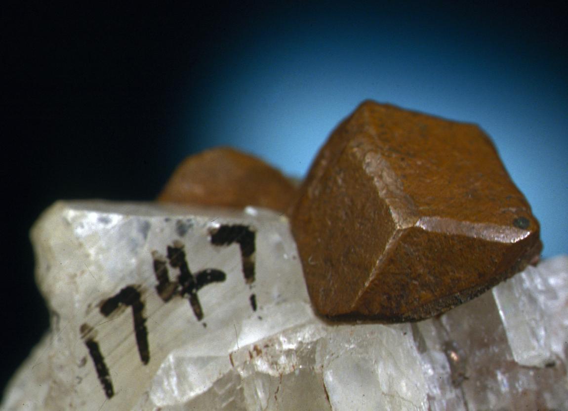 Copper, Franklin Mine, Houghton County, Michigan. A sharp dodecahedral crystal of copper on calcite. From the collection of J. T. Reeder. Field of view is about 4 cm wide. Photo by J. Jaszczak. (JTR 1747)