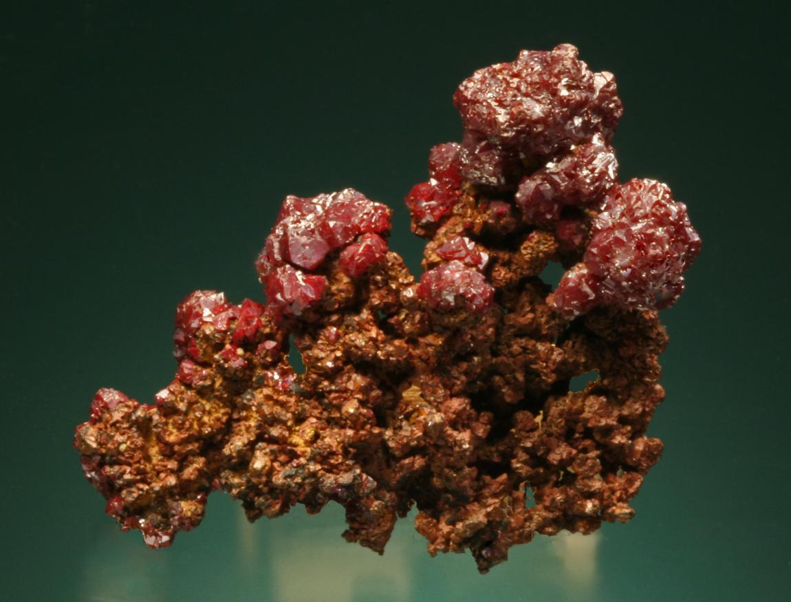 Cuprite, copper, Copper Queen Mine, Bisbee, Arizona. Sharp, red cuprite crystals on fine copper crystals. Specimen 4. 5 cm wide. Photo by G. Robinson. (DM 13293)