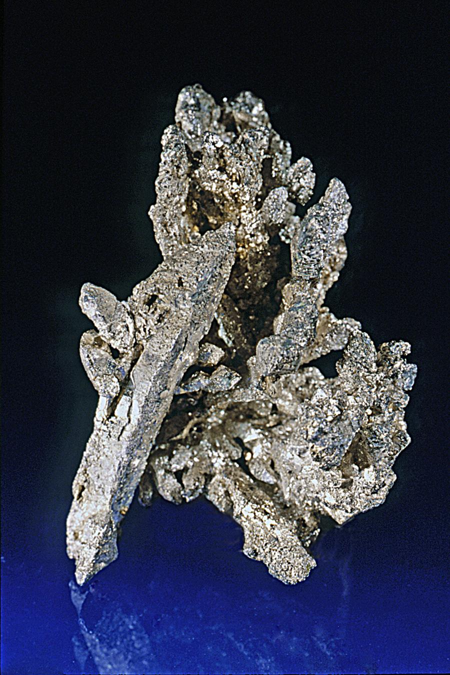 Silver, Kearsarge Mine, Houghton County, Michigan. A large spinel twin of silver on smaller silver crystals from one of Michigan’s premier silver localities. Specimen 6 cm tall. Photo by J. Jaszczak. (JTR 405).